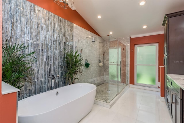 bathroom with vaulted ceiling, shower with separate bathtub, tile patterned flooring, and vanity