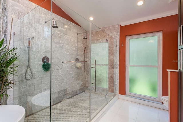 bathroom with tile patterned flooring, vaulted ceiling, walk in shower, and toilet