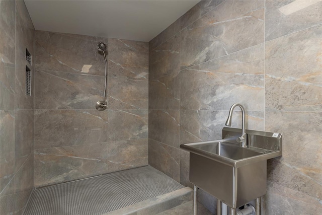 bathroom with sink and tiled shower