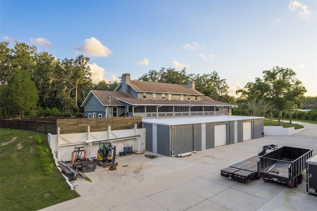 back of property with a patio, an outbuilding, and a garage