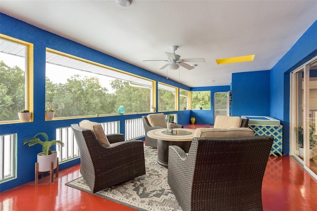 sunroom / solarium with ceiling fan and plenty of natural light