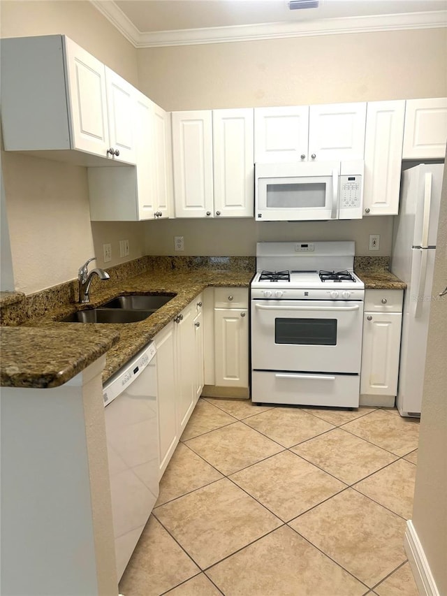 kitchen with white cabinetry, sink, dark stone countertops, crown molding, and white appliances