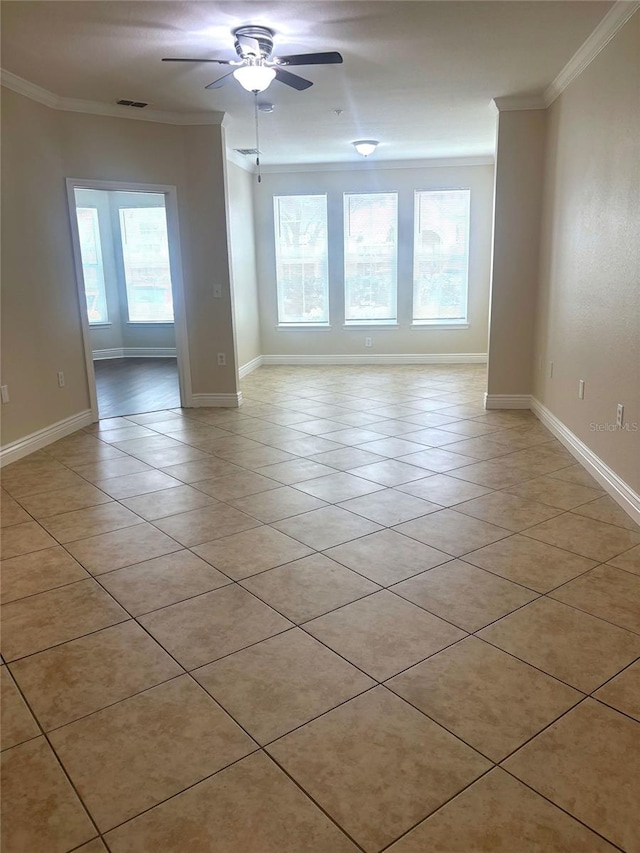 tiled spare room with crown molding, ceiling fan, and a healthy amount of sunlight