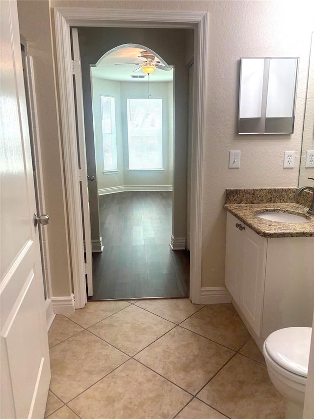 bathroom featuring vanity, tile patterned floors, ceiling fan, and toilet