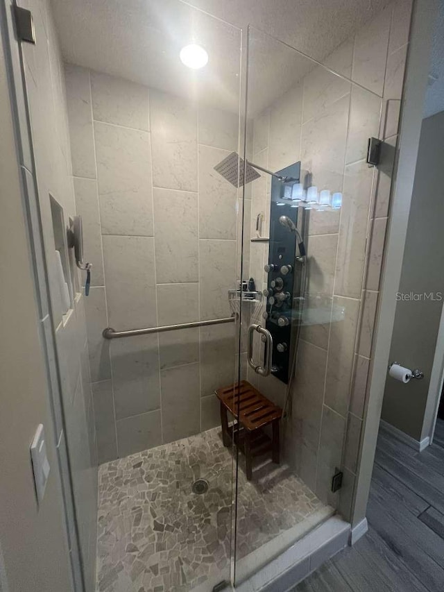 bathroom with a shower with shower door