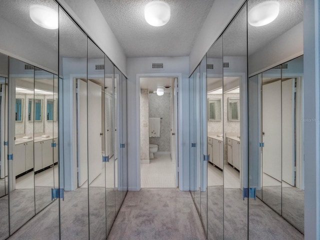 bathroom featuring toilet and a textured ceiling