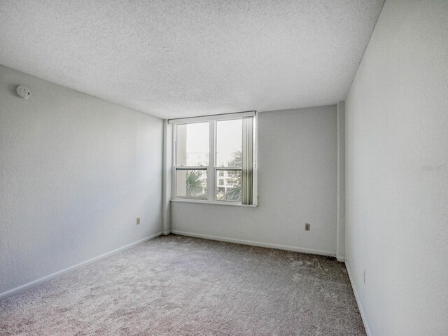 empty room featuring carpet floors and a textured ceiling