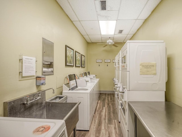 laundry area with separate washer and dryer, stacked washer / drying machine, dark wood-type flooring, and ceiling fan