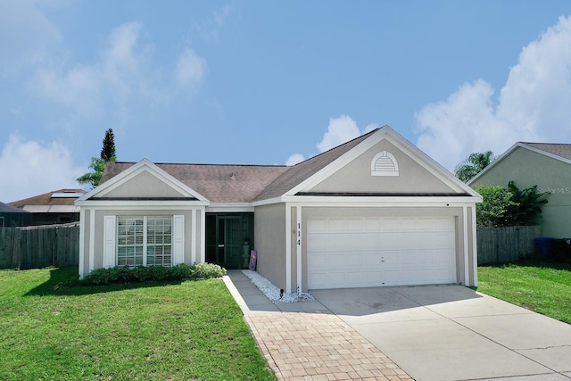 ranch-style house featuring driveway, an attached garage, fence, a front lawn, and stucco siding