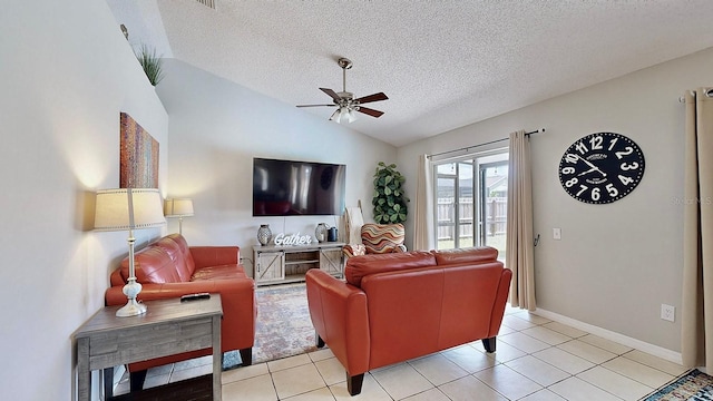 living room featuring lofted ceiling, a textured ceiling, light tile patterned flooring, a ceiling fan, and baseboards