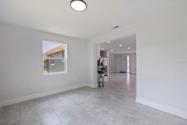 unfurnished room with light tile patterned floors