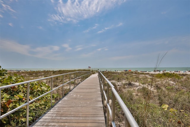 dock area featuring a beach view and a water view