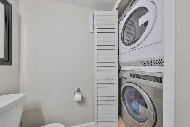 laundry room featuring stacked washer / dryer