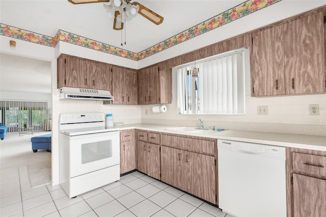 kitchen featuring sink, ceiling fan, white appliances, and light colored carpet