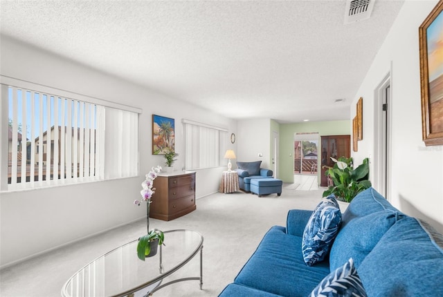 living room with light carpet and a textured ceiling