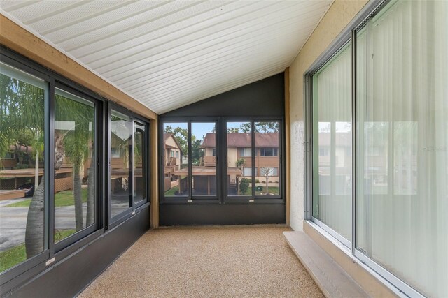 unfurnished sunroom featuring lofted ceiling