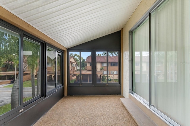 unfurnished sunroom featuring vaulted ceiling