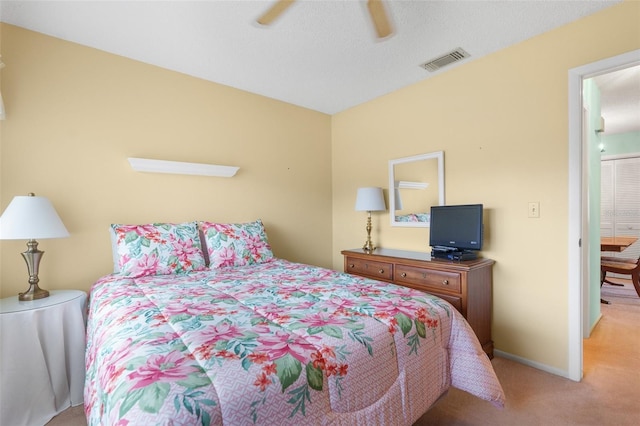 bedroom featuring a textured ceiling, carpet, and ceiling fan