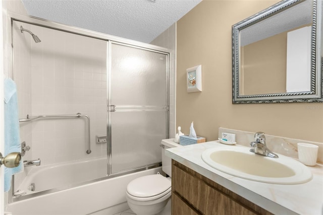 full bathroom with vanity, combined bath / shower with glass door, a textured ceiling, and toilet