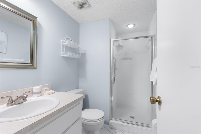 bathroom featuring a textured ceiling, a shower with shower door, toilet, vanity, and tile patterned floors