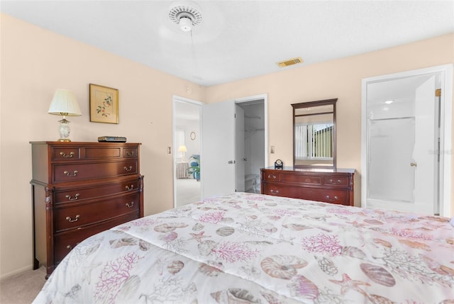 bedroom featuring a walk in closet, a closet, and carpet flooring