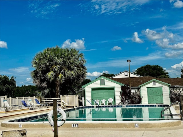 view of pool featuring a storage shed