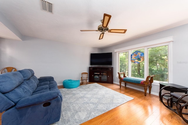 living room with ceiling fan and light hardwood / wood-style floors