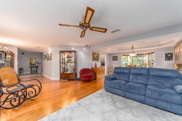 living room with wood-type flooring and ceiling fan