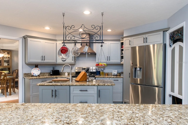 kitchen featuring light stone counters, gray cabinets, stainless steel appliances, and sink