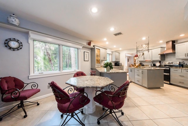 dining area with light tile patterned flooring