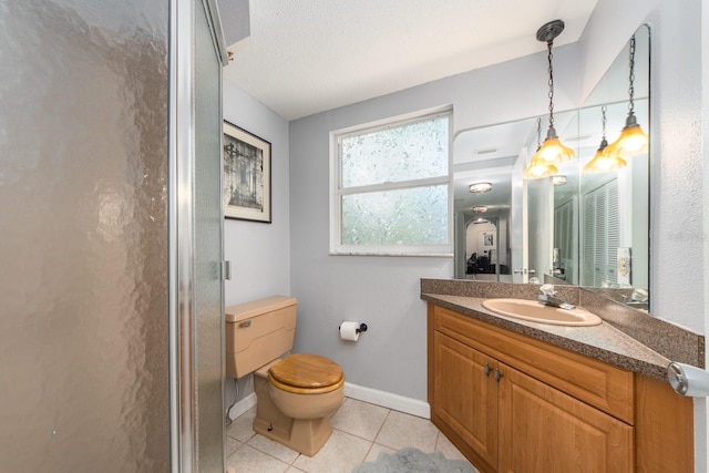 bathroom with vanity, toilet, a shower with door, and tile patterned floors