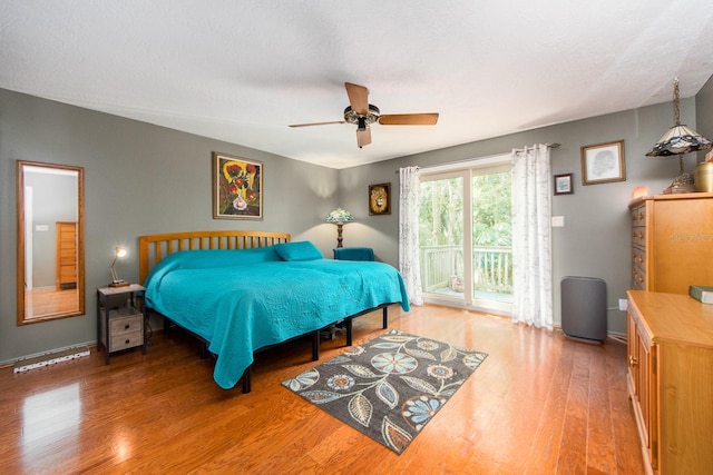 bedroom featuring ceiling fan, hardwood / wood-style flooring, and access to outside