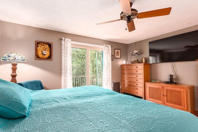 bedroom featuring ceiling fan and access to exterior