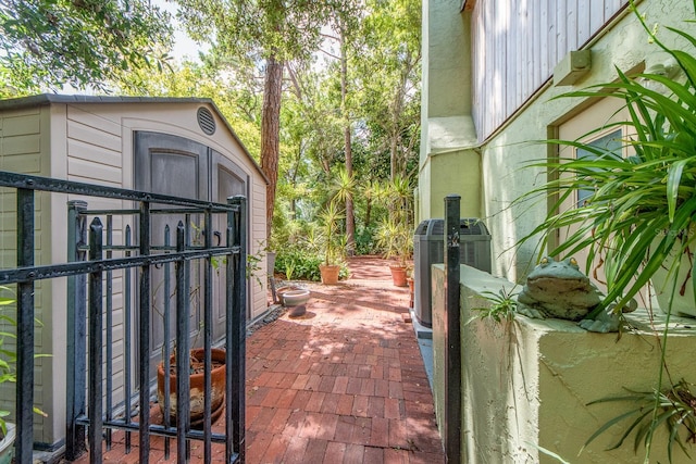 exterior space featuring a storage unit and central AC