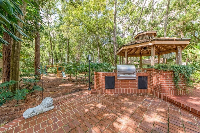 view of patio featuring a gazebo, area for grilling, and an outdoor kitchen