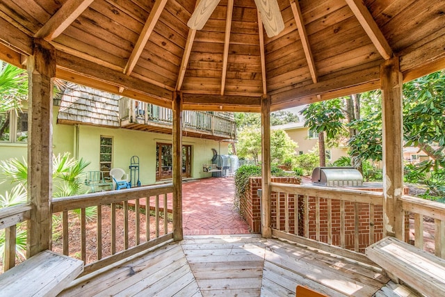 deck featuring grilling area, a patio area, and exterior kitchen