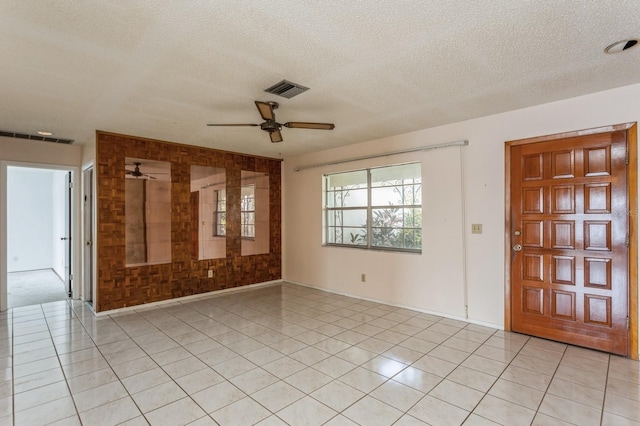 entryway featuring light tile patterned floors, visible vents, and a textured ceiling