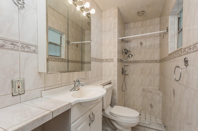 full bathroom featuring vanity, a tile shower, tile walls, toilet, and backsplash