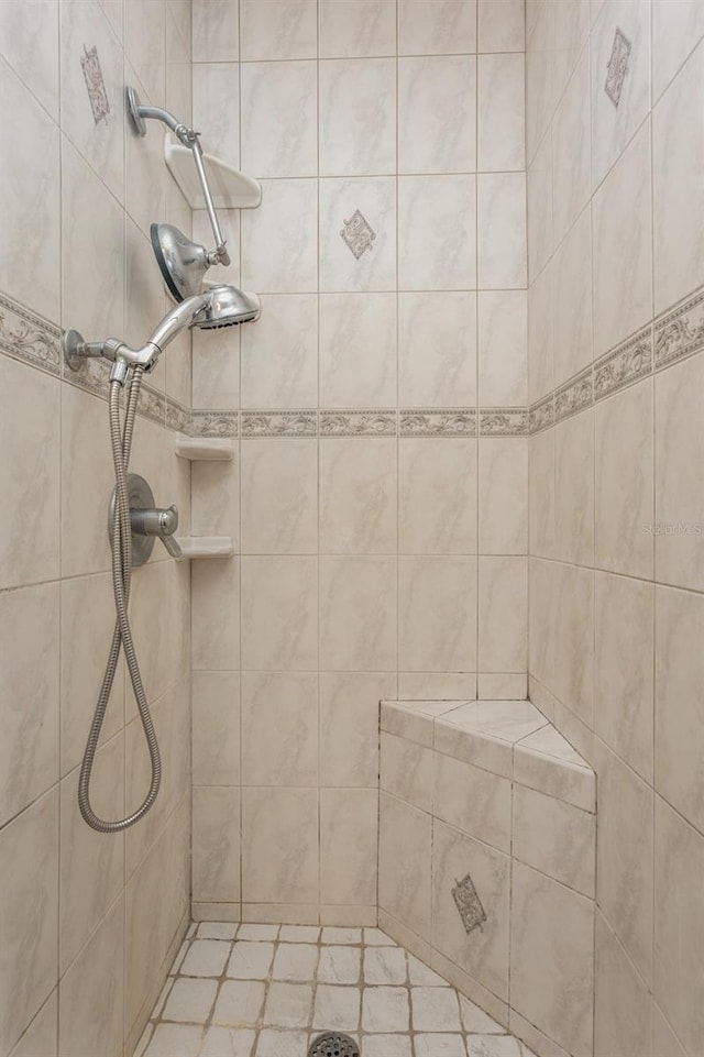 full bath with a tile shower