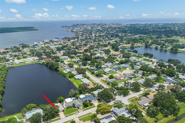 drone / aerial view with a residential view and a water view