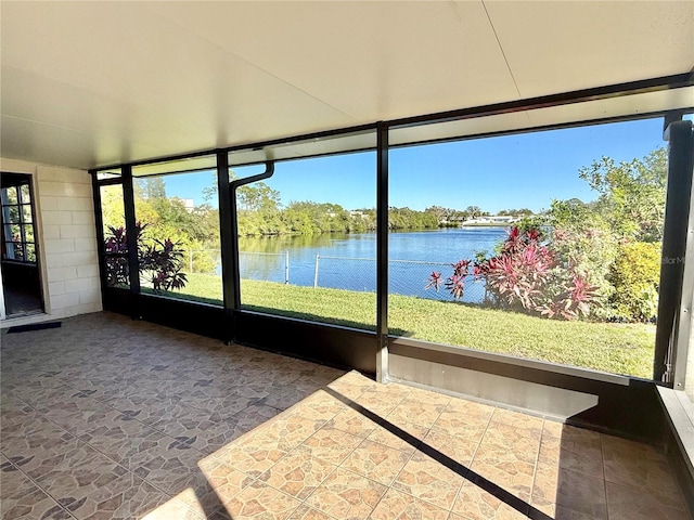 unfurnished sunroom featuring a healthy amount of sunlight and a water view