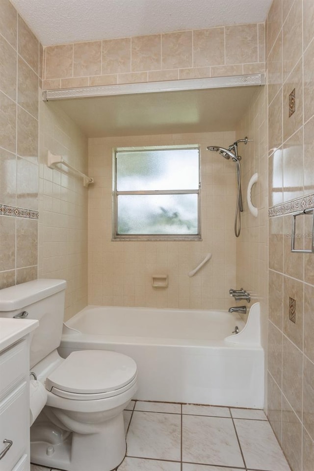 bathroom with shower / bath combination, a textured ceiling, tile walls, and vanity