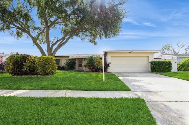 ranch-style home with a garage and a front yard