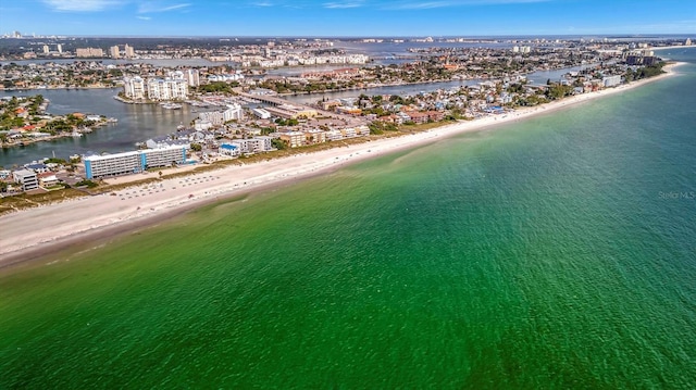 birds eye view of property with a water view and a beach view