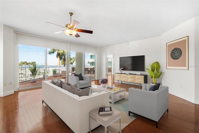 living room with ceiling fan and dark hardwood / wood-style flooring