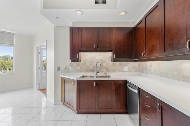 kitchen featuring light tile patterned floors, backsplash, stainless steel dishwasher, and sink