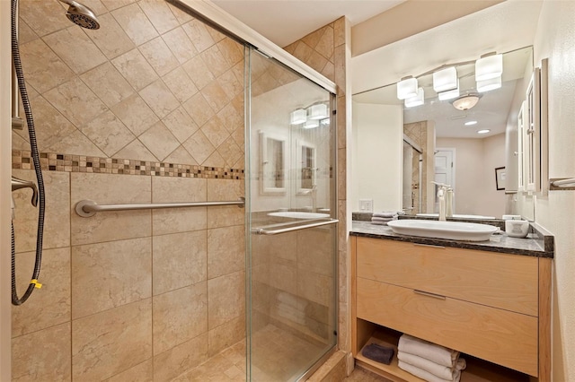 bathroom with vanity and a shower with shower door