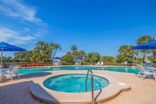 view of swimming pool featuring a community hot tub and a patio area