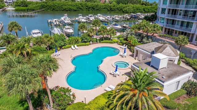 view of pool with a patio and a water view