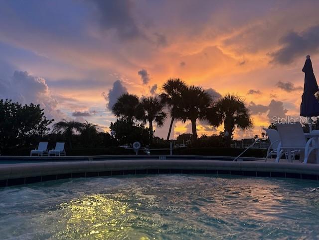 view of pool at dusk